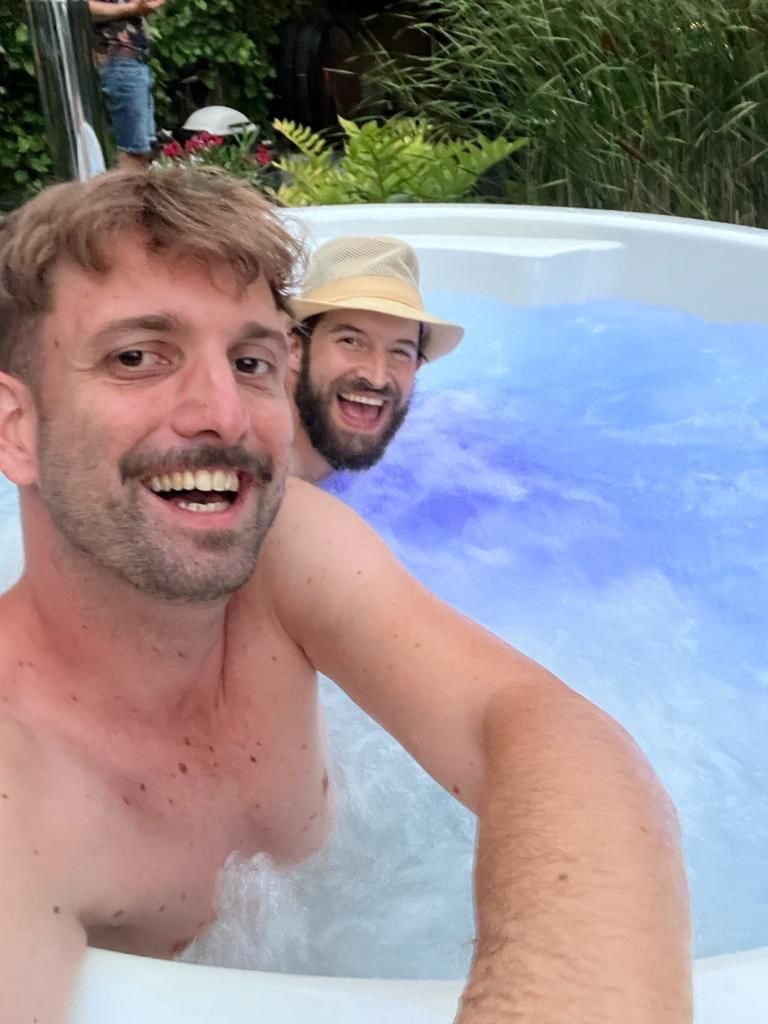 Gardenvity wood fired hot tub with two people relaxing in an scandinavian-style design outdoors.